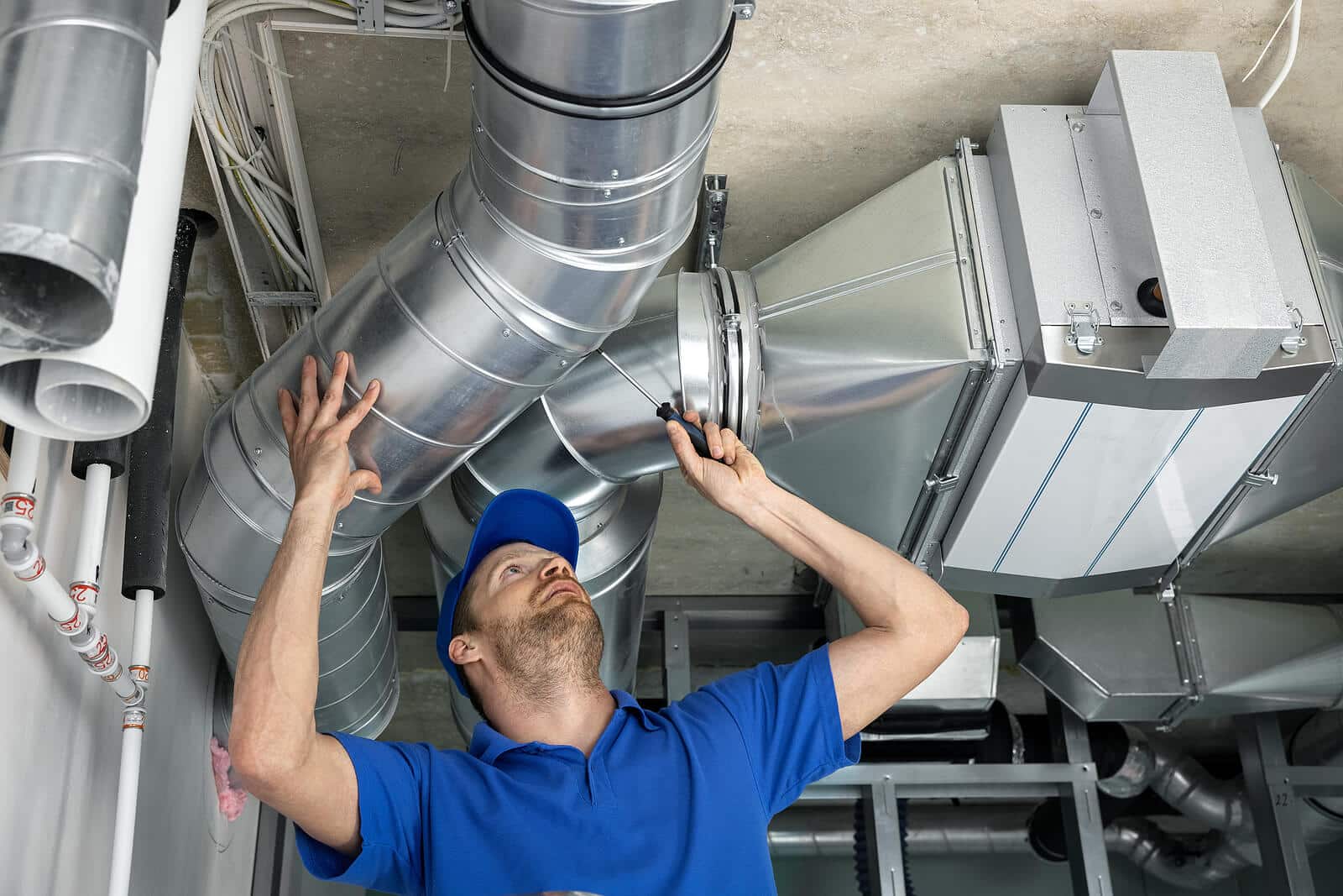 HVAC technician inspecting and repairing air ducts in Hacienda Heights
