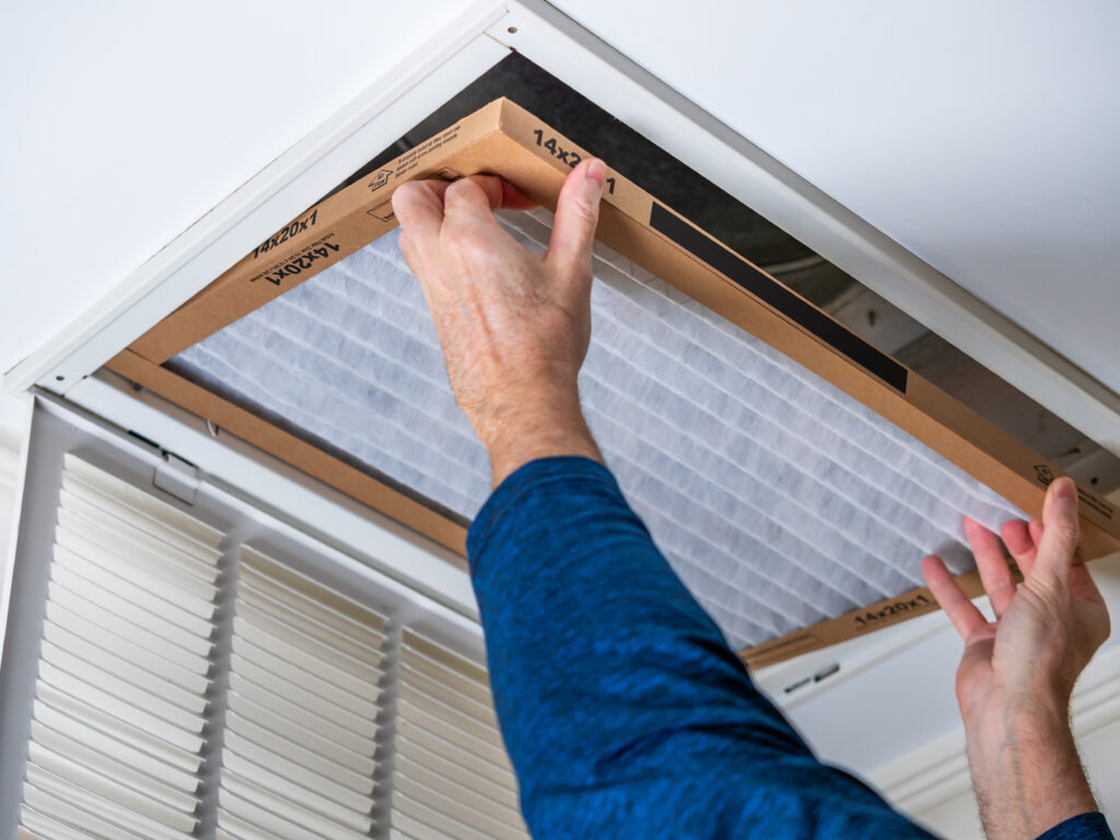 HVAC technician replacing a home air filter in Hacienda Heights