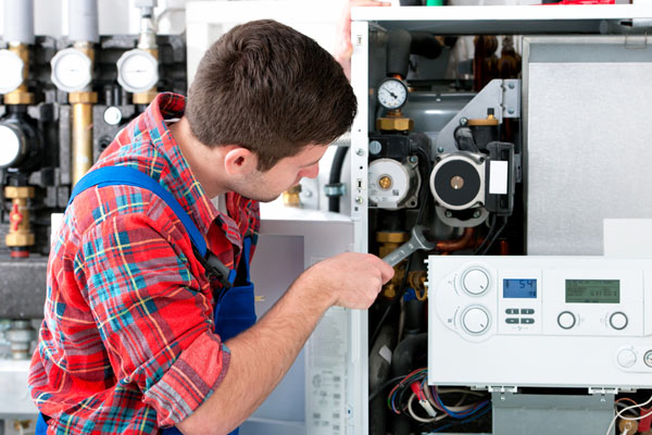 Heating technician repairing boiler controls in Hacienda Heights