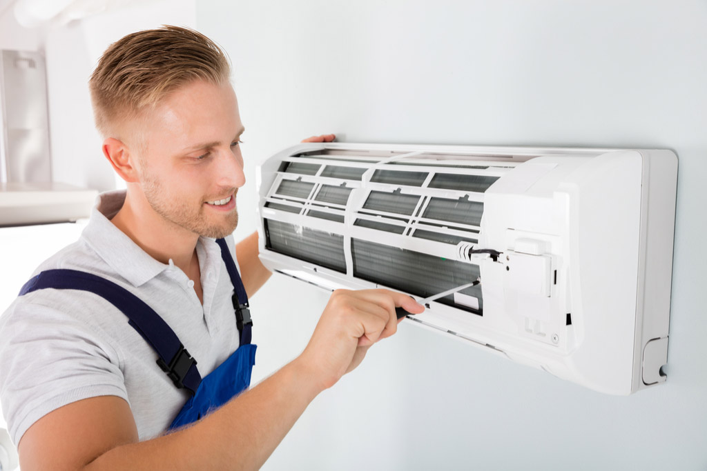 HVAC technician maintaining a ductless air conditioner in Hacienda Heights