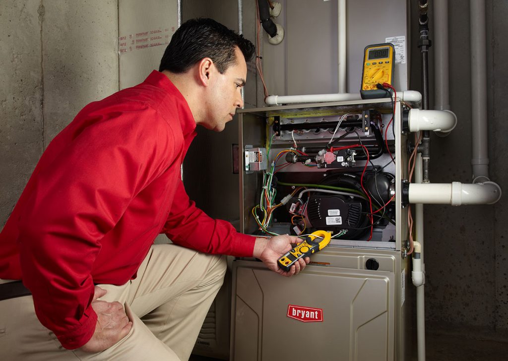 Heating technician diagnosing a furnace repair in Hacienda Heights