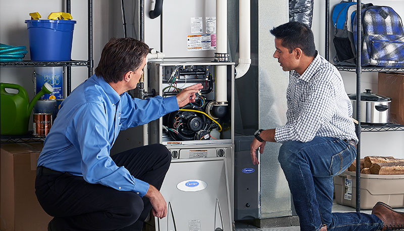 Technician evaluating a furnace for repair or replacement in Hacienda Heights