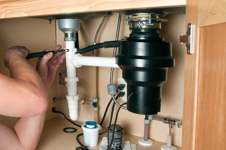 Plumber repairing a garbage disposal in Hacienda Heights