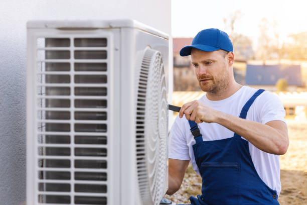 HVAC technician servicing an outdoor air conditioner in Hacienda Heights
